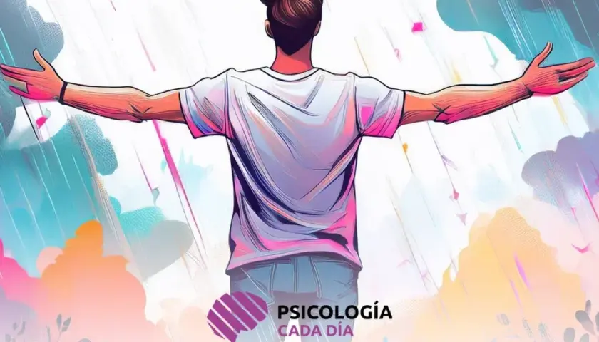 Hombre con brazos extendidos, abrazando la lluvia de colores. Un símbolo de cambio de perspectiva y aceptación.