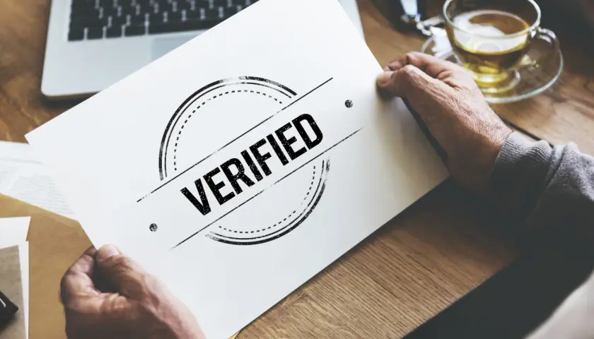 Man holding a paper with "VERIFIED" stamp, symbolizing a certificado profesionalidad online.